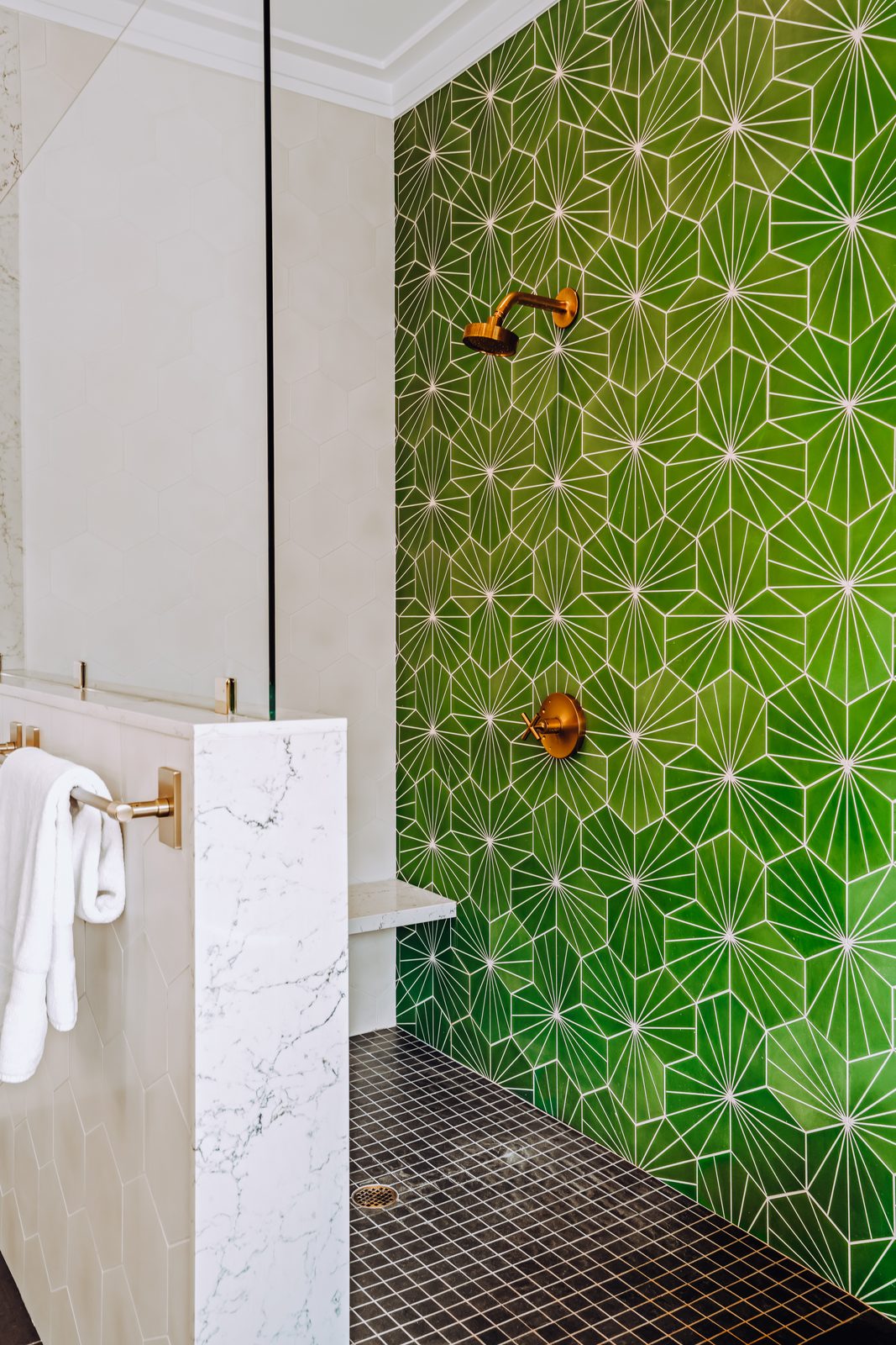 Marble walk-in shower set against the green star tile