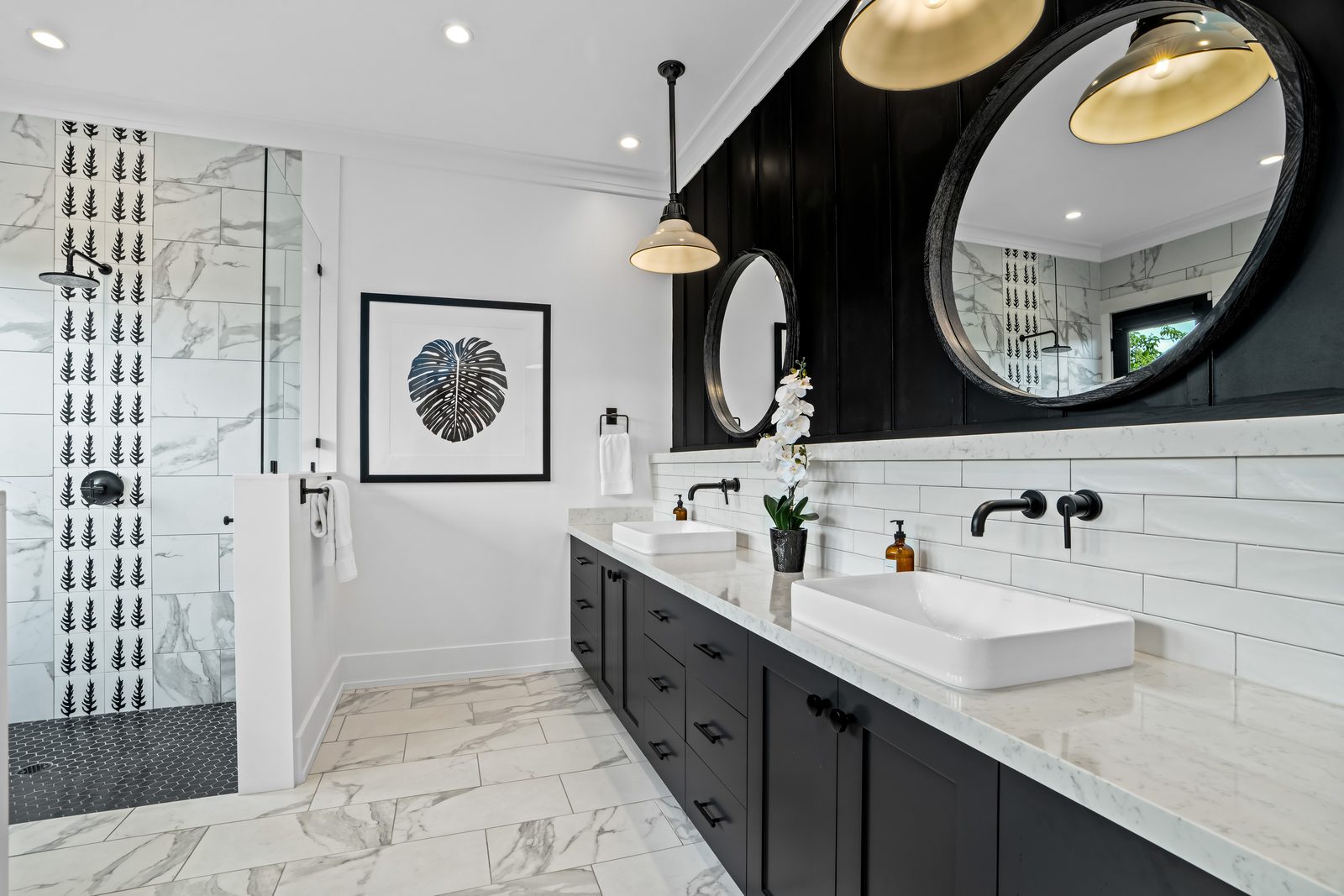 Coral Room bathroom in black and white marble with twin basins and a walk-in shower