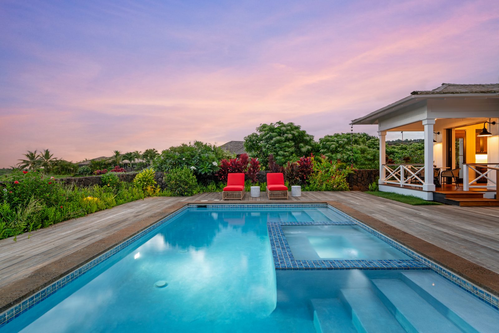 The pool and spa at dusk under a pink sky