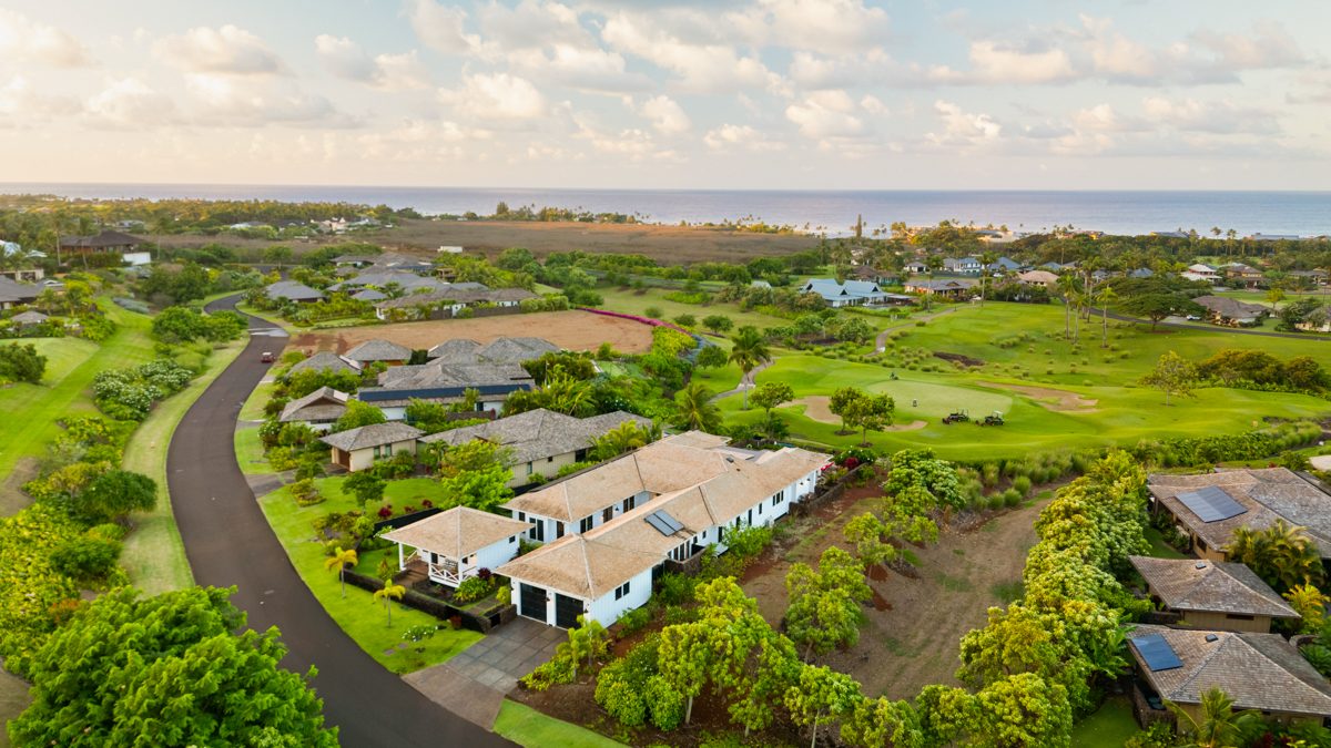 Aerial view of the neighbourhood with the house and the sea beyond