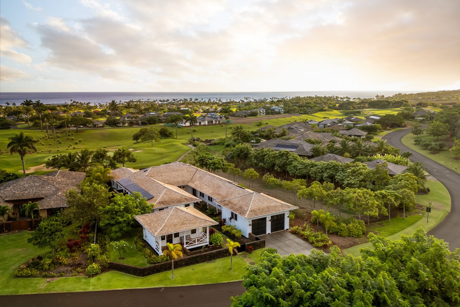 Aerial view over the house towards the ocean and golf course